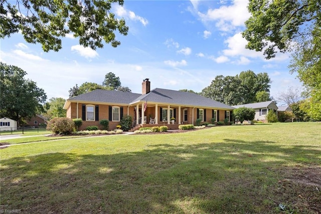 ranch-style home featuring a porch and a front yard