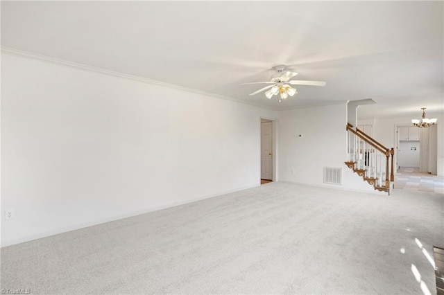 unfurnished room with crown molding, light colored carpet, and ceiling fan with notable chandelier