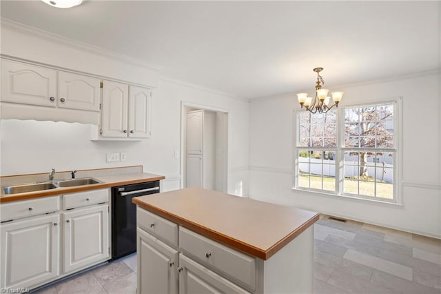 kitchen featuring sink, black dishwasher, a chandelier, pendant lighting, and white cabinets