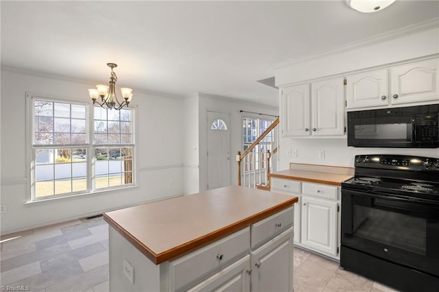 kitchen with a center island, white cabinetry, hanging light fixtures, and black appliances