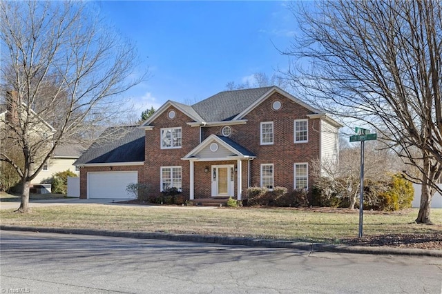 view of front of property with a front yard and a garage