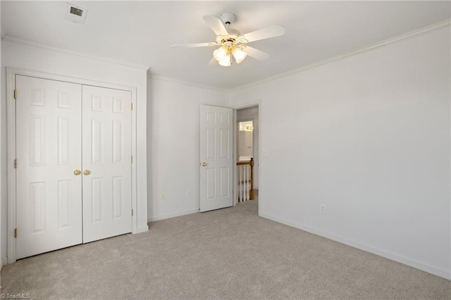 unfurnished bedroom with light carpet, a closet, ceiling fan, and ornamental molding