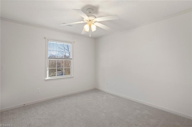 spare room with ceiling fan, carpet floors, and ornamental molding