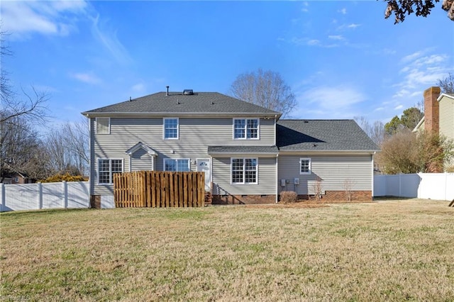 rear view of property featuring a yard