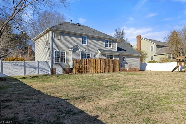 rear view of house featuring a playground and a yard