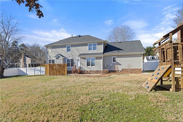 rear view of house featuring a playground and a yard