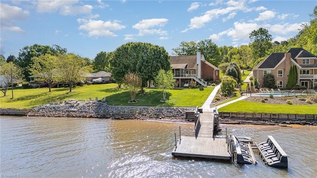 dock with a water view, a yard, and stairway