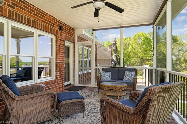 sunroom with a ceiling fan, plenty of natural light, and an outdoor hangout area