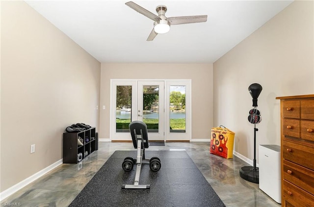 exercise room with ceiling fan and baseboards
