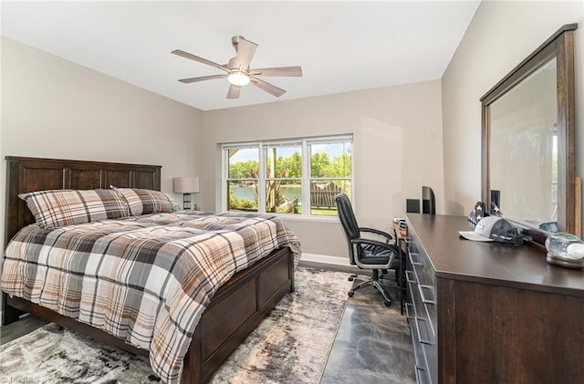 bedroom featuring an office area, baseboards, and a ceiling fan