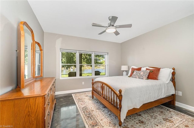 bedroom with baseboards, a ceiling fan, and finished concrete floors