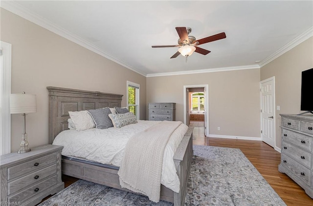 bedroom featuring crown molding, wood finished floors, baseboards, ceiling fan, and ensuite bathroom