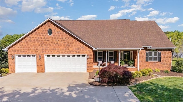 view of front of property featuring driveway, covered porch, brick siding, a garage, and roof with shingles