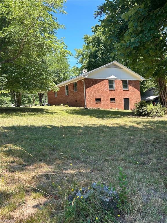 view of property exterior with a yard