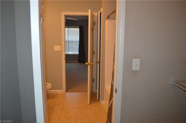 hall featuring light tile patterned floors