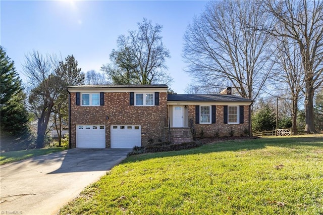 tri-level home with a garage and a front yard