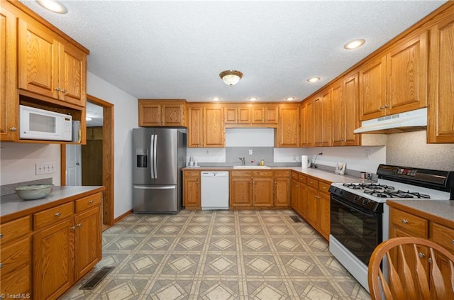 kitchen with white appliances and sink