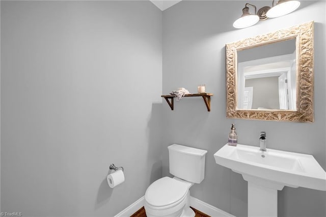 bathroom featuring sink and toilet