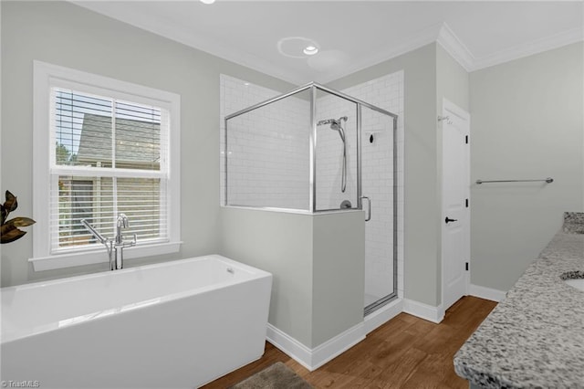 bathroom with vanity, wood-type flooring, ornamental molding, and independent shower and bath