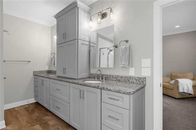 bathroom with ornamental molding, hardwood / wood-style floors, vanity, and walk in shower