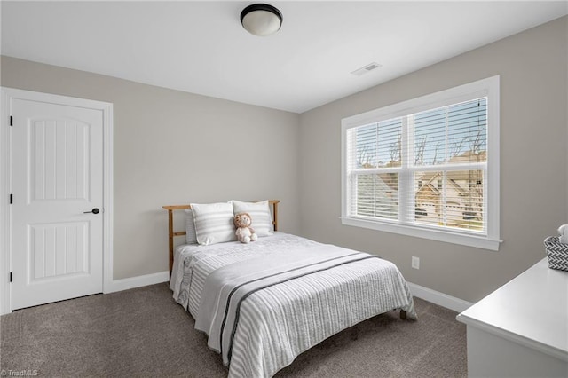 bedroom with dark colored carpet