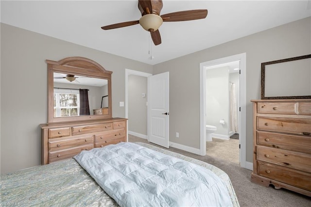 carpeted bedroom with ceiling fan and ensuite bath