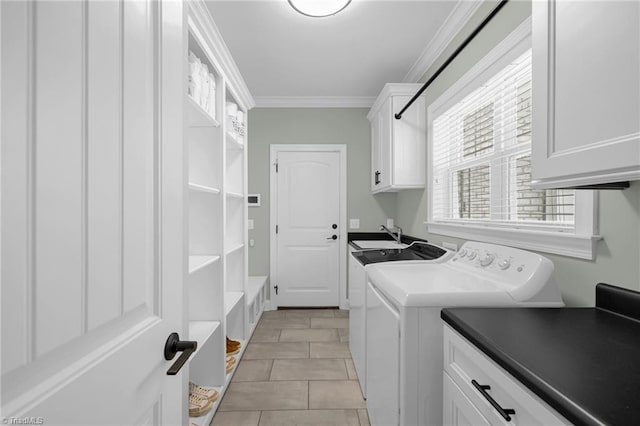 washroom with light tile patterned flooring, washer and dryer, sink, cabinets, and crown molding