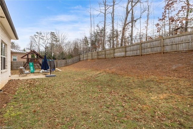 view of yard with a patio and a playground