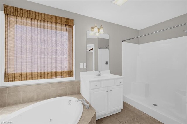 bathroom with a shower, vanity, tile patterned flooring, and a bath