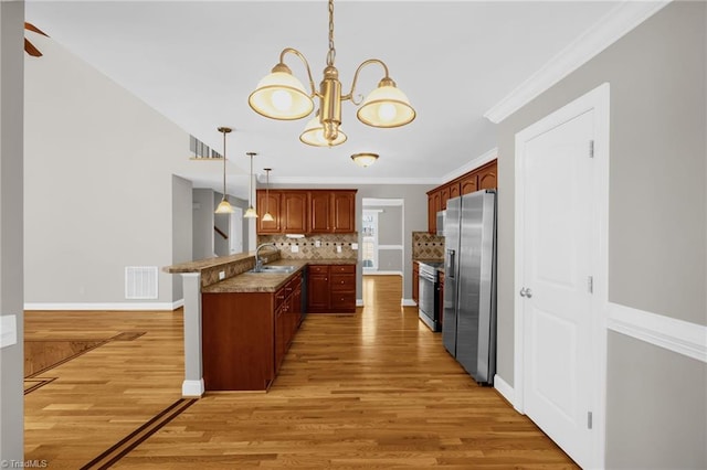 kitchen with a sink, light wood-style floors, a peninsula, stainless steel refrigerator with ice dispenser, and visible vents