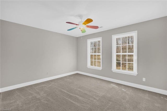 unfurnished room with baseboards, carpet, and a ceiling fan
