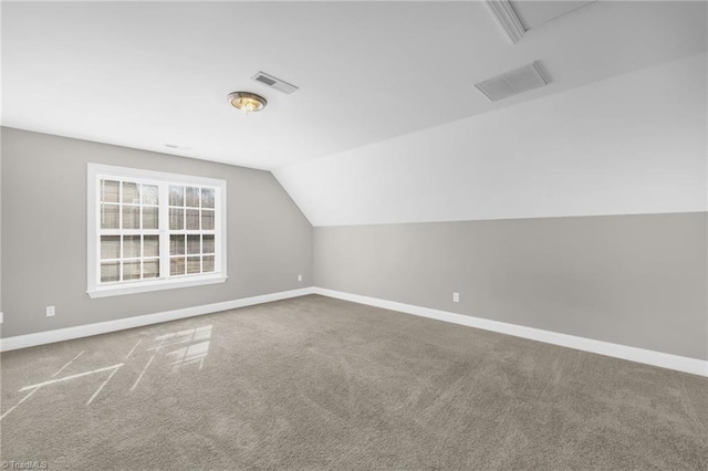 bonus room featuring visible vents, baseboards, carpet floors, and vaulted ceiling