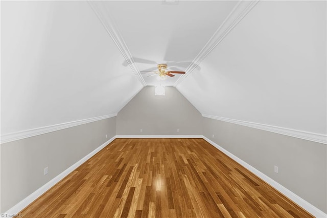 bonus room with baseboards, ceiling fan, vaulted ceiling, and wood finished floors