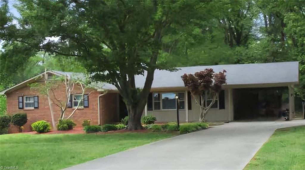 ranch-style home with a front yard and a carport