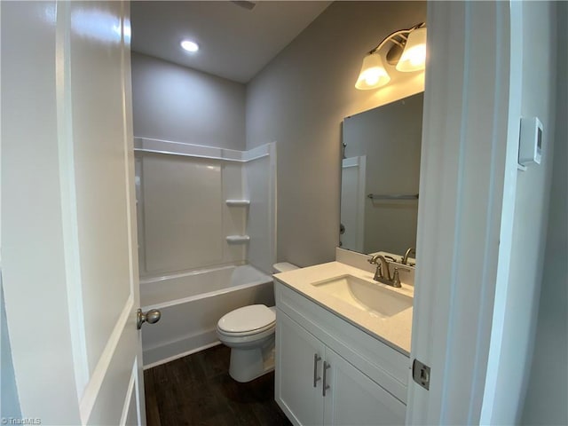 full bathroom with toilet, shower / washtub combination, wood finished floors, and vanity