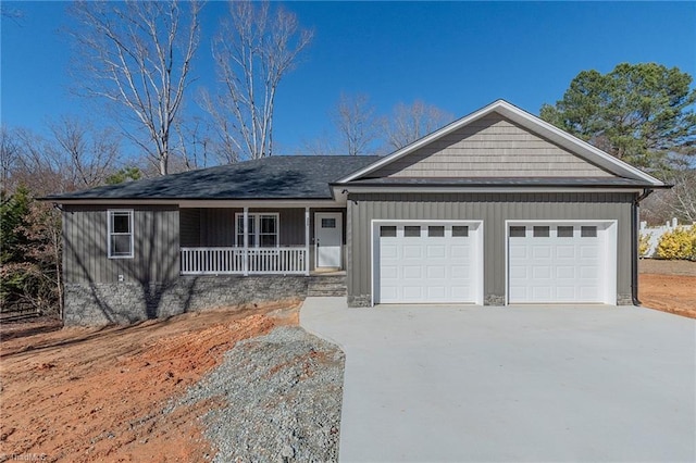 single story home featuring a garage, driveway, and a porch