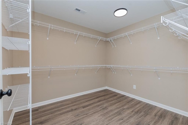 spacious closet featuring visible vents and wood finished floors