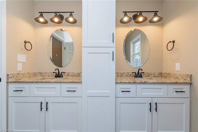 bathroom featuring double vanity and a sink