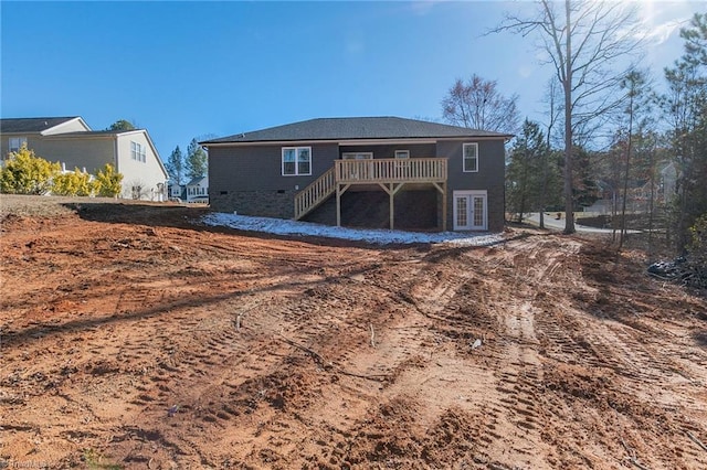 rear view of house featuring a deck and french doors