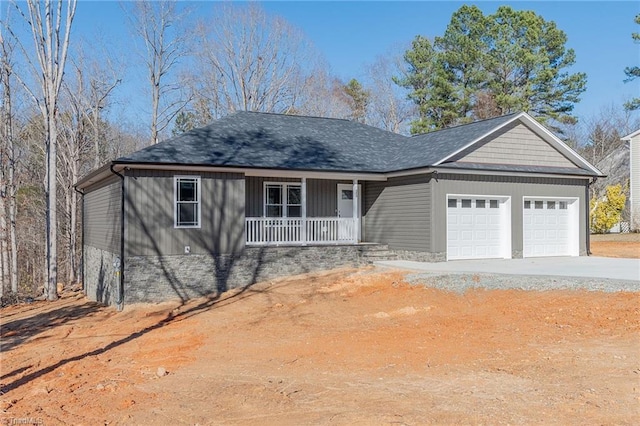 ranch-style home featuring covered porch, driveway, and an attached garage