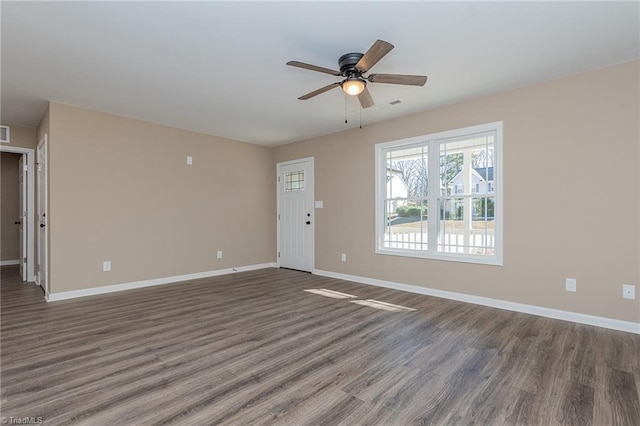 unfurnished living room featuring ceiling fan, visible vents, baseboards, and dark wood-style flooring