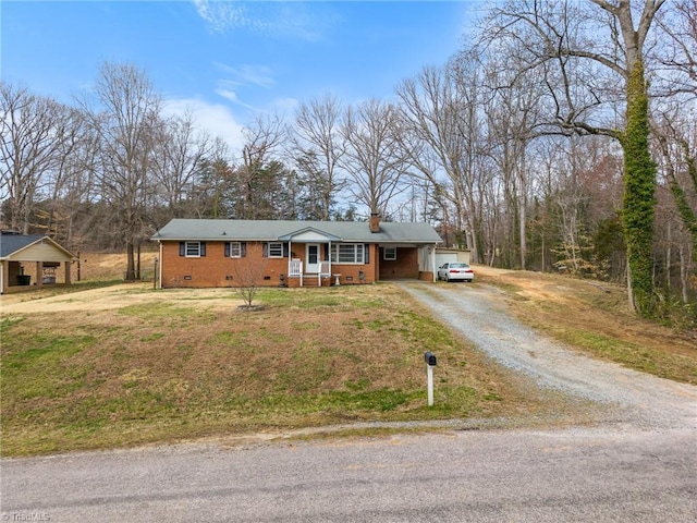 single story home with crawl space, a chimney, brick siding, and dirt driveway