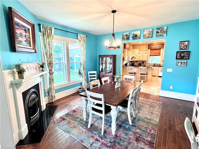 311 Cherry St, Mount Airy, NC 27030 - dining area with a fireplace with flush hearth, baseboards, and wood finished floors