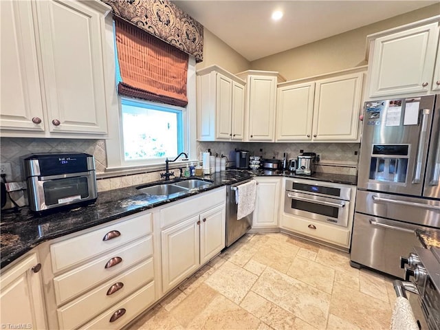 311 Cherry St, Mount Airy, NC 27030 - kitchen with stainless steel appliances, a sink, backsplash, white cabinetry, and recessed lighting