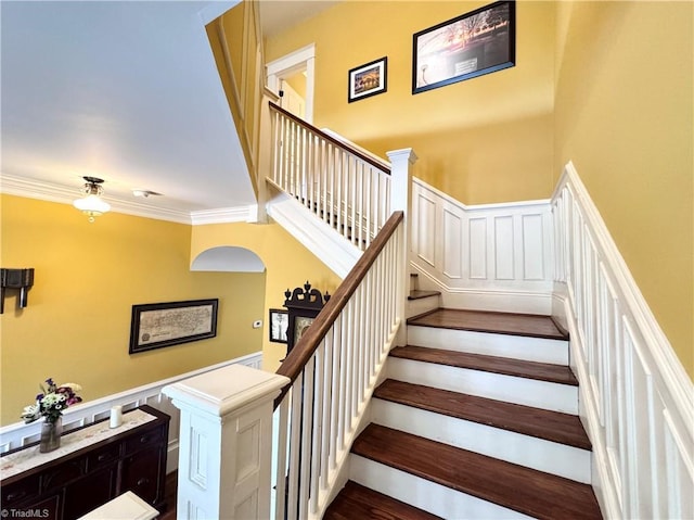 311 Cherry St, Mount Airy, NC 27030 - stairway with ornamental molding, wainscoting, a decorative wall, and wood finished floors