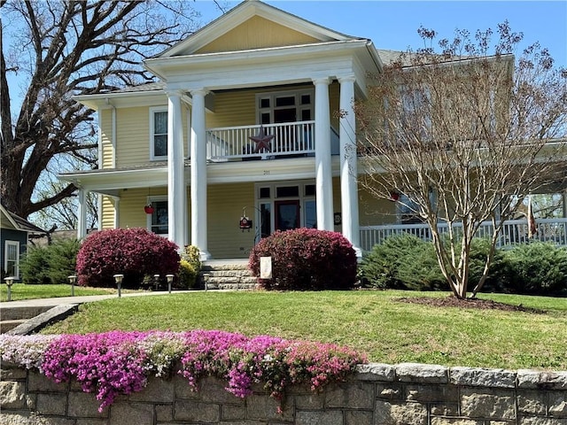 311 Cherry St, Mount Airy, NC 27030 - neoclassical home with covered porch, a balcony, and a front yard