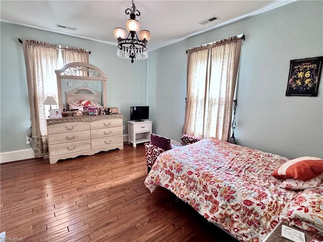 311 Cherry St, Mount Airy, NC 27030 - bedroom with a chandelier, wood-type flooring, crown molding, and baseboards