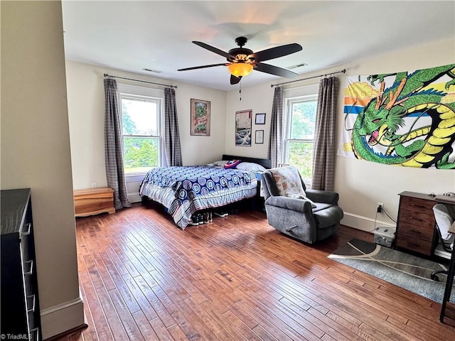 311 Cherry St, Mount Airy, NC 27030 - bedroom featuring multiple windows, wood-type flooring, baseboards, and ceiling fan