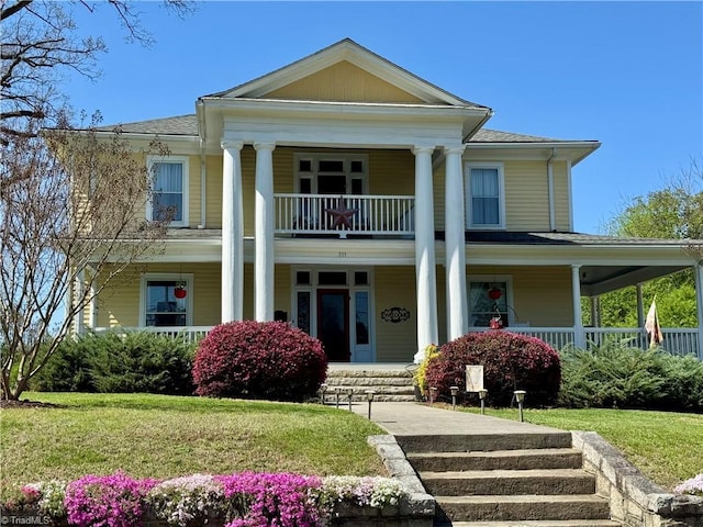 311 Cherry St, Mount Airy, NC 27030 - greek revival house featuring a porch, a balcony, and a front yard