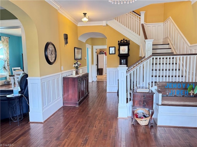 311 Cherry St, Mount Airy, NC 27030 - entrance foyer with dark wood-type flooring, arched walkways, stairs, ornamental molding, and wainscoting